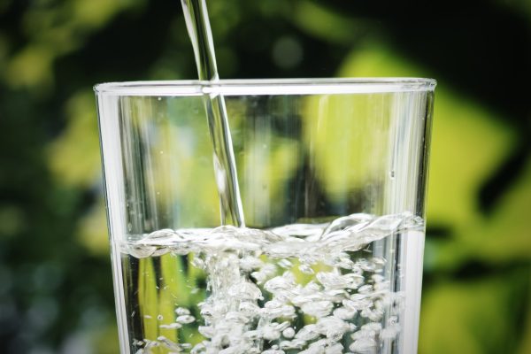 Macro shot of pouring water into a glass